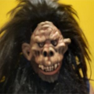 Evil chimpanzee mask with full head of hair.Adult